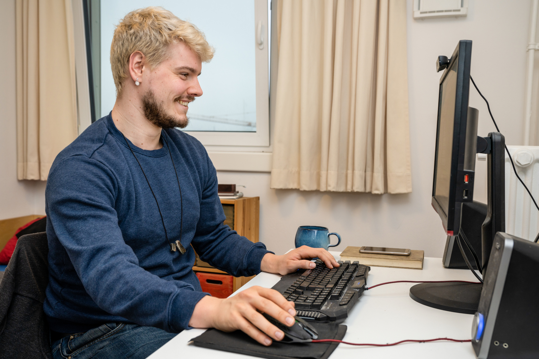 Young man sitting at a desk working on his computer